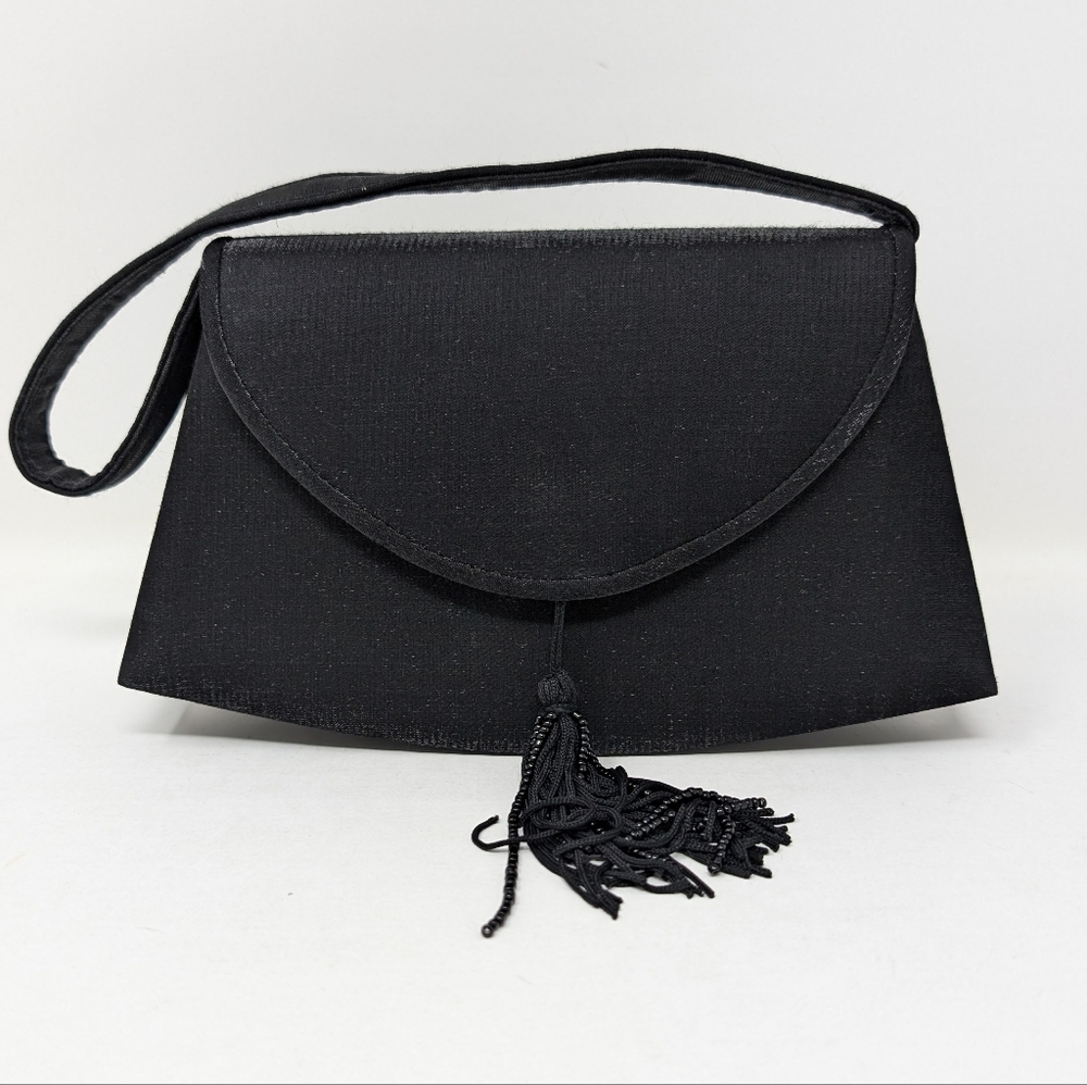 Small black fabric bag with tassel. Convertible